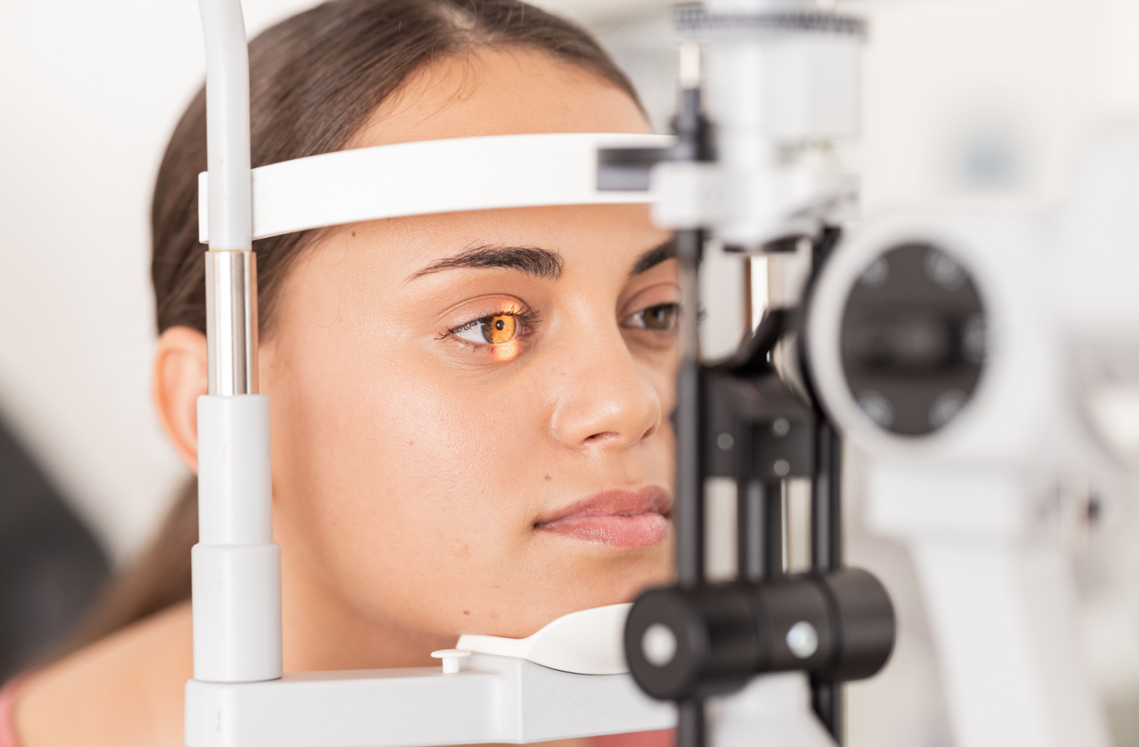 Close-up of a woman undergoing a slit-lamp exam