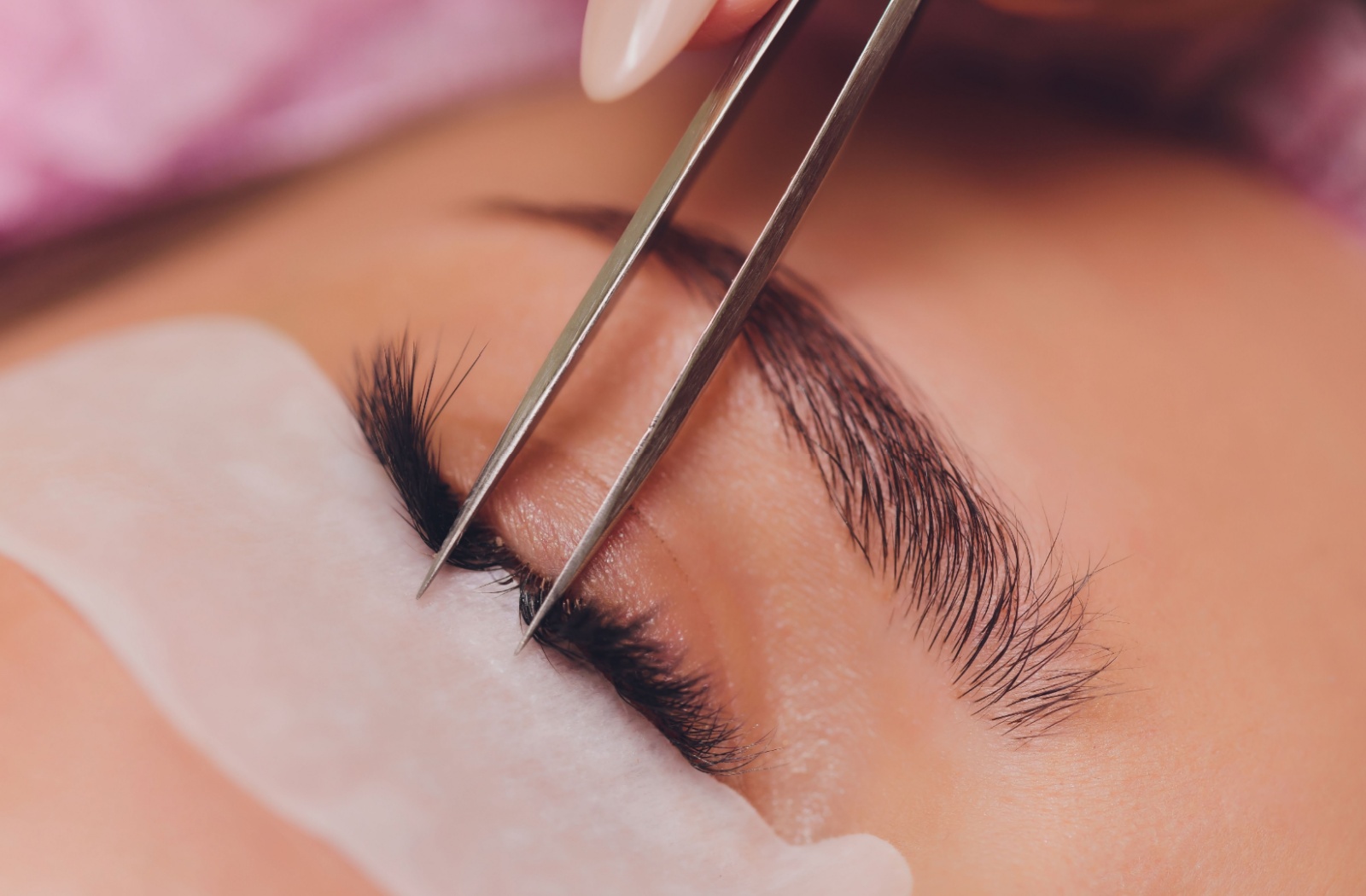 A close up of someone getting eyelash extensions