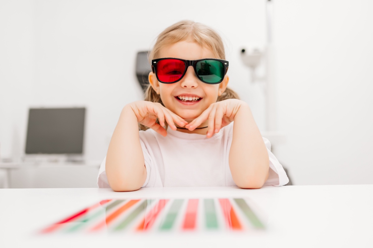 Elementary school-aged girl wearing special red green glasses during vision therapy.